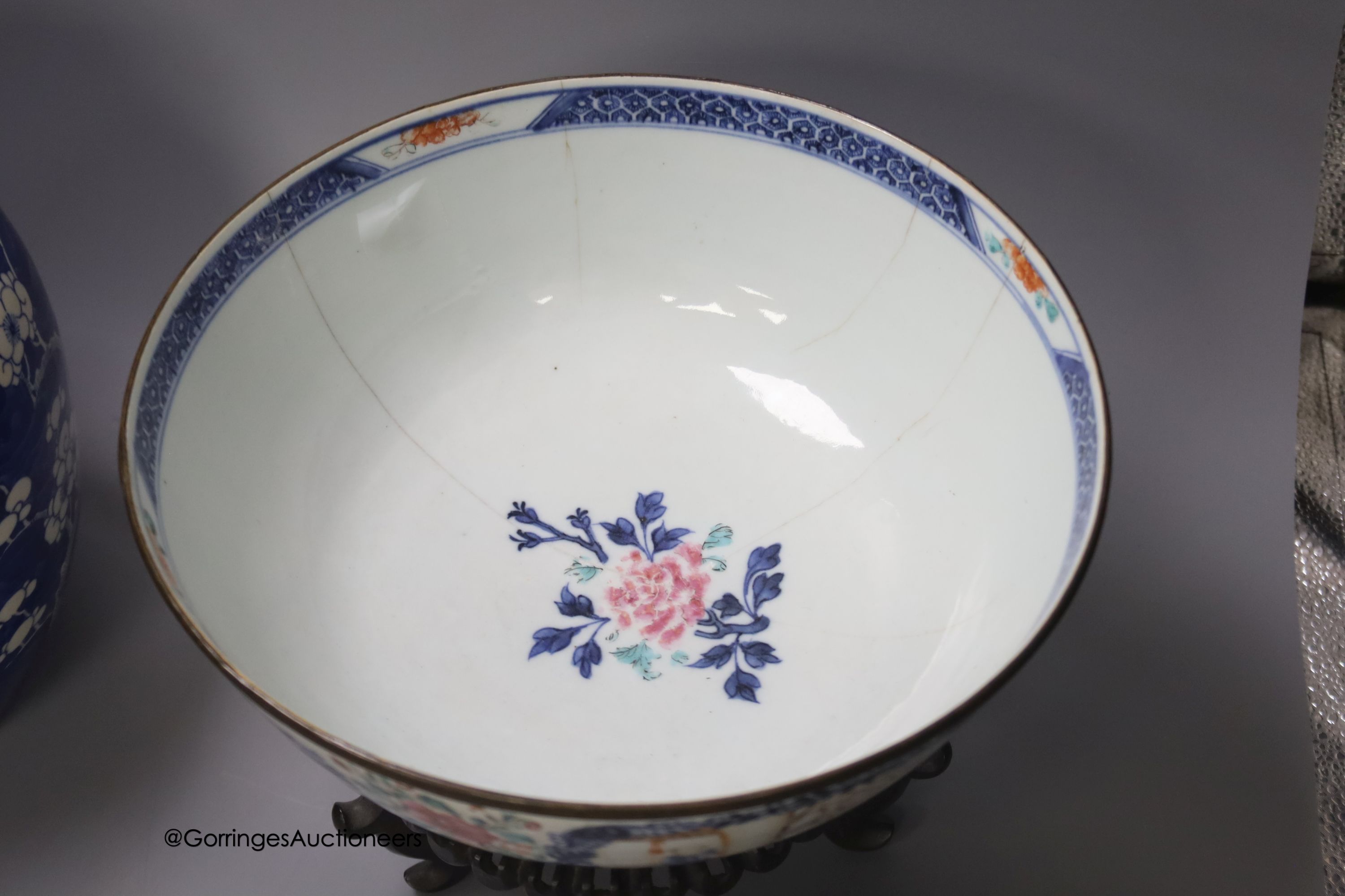A 19th century Chinese porcelain prunus jar and cover, 27cm, on carved wood stand, a smaller famille noire jar and cover, a Chinese export fruit bowl, blue and white dish and a similar jar and cover 27cm
